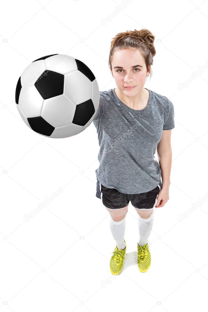 Teen holding Soccer ball with one hand. 
