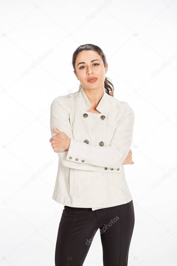 Young professional woman dressed for business with arms folded l