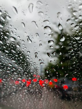 Abstract view of traffic on a busy urban street on a wet rainy day. 