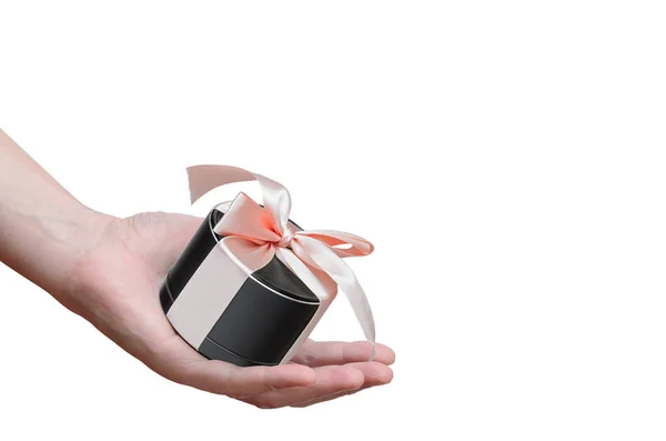 Portable mobile speaker, tied with a pink ribbon the hand of man — Stock Photo, Image