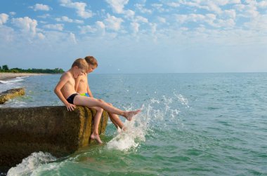 Two teenagers have fun during a vacation by the sea
