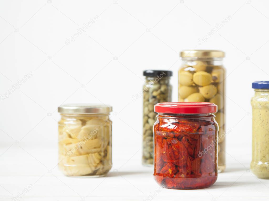 Variety of typical Italian food preserved in glass jars.