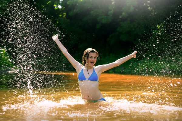 Yong happy girl relaxing in the forest river — Stock Photo, Image