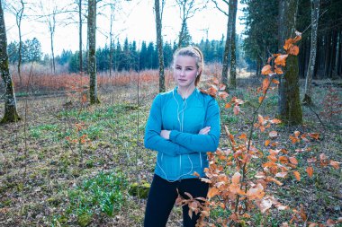 Genç kız bahar vakti ormanda koşuyor.