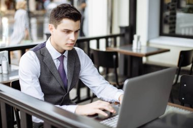 Kafede dizüstü bilgisayarda yazarak başarılı genç işadamı