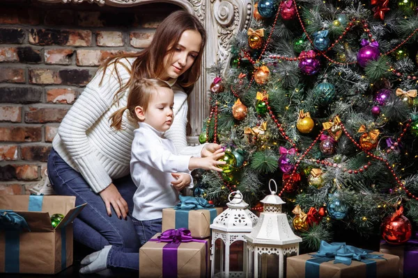 Happy family mom and daughter decorate Christmas tree at home. — Stock Photo, Image