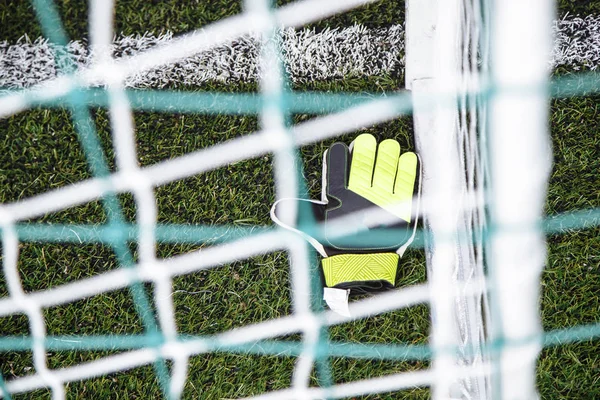 Вид сверху на вратарские перчатки, лежащие на футбольном поле . — стоковое фото