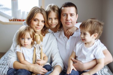 Portrait of happy family with three children clipart