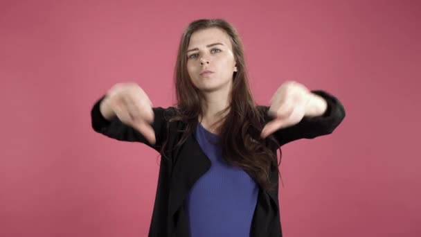 Portrait Displeased Young Woman Showing Thumb Pink Background Dislike Sign — Stock Video