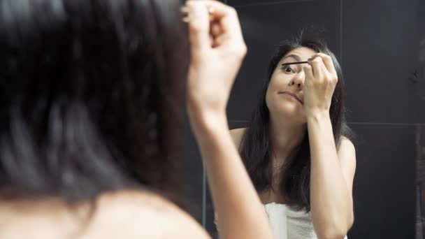 Attractive Young Woman Looking Mirror Applying Mascara Her Eyes Bathroom — Stock Video