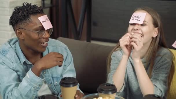 Diverse Group Friends Playing Who Game Sticky Papers Attached Foreheads — Stock Video