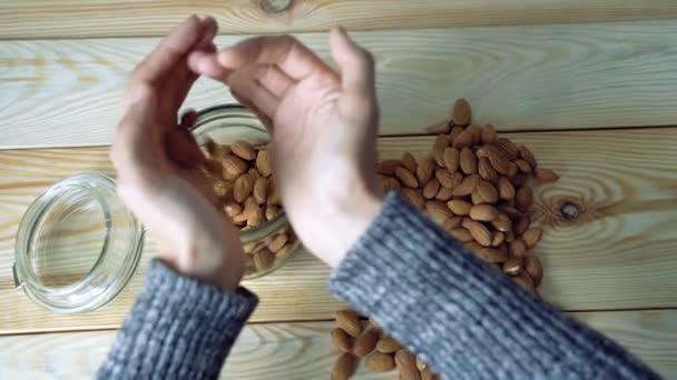 Manos Femeninas Moviendo Almendras Frasco Vidrio Vista Superior — Vídeo de stock