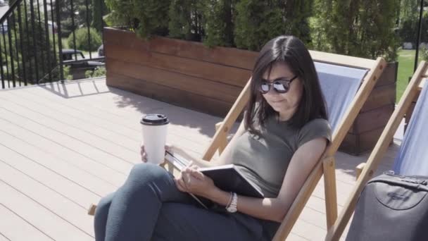 Young Woman Reading Book Sitting Sun Lounger Sunny Day — Stock Video