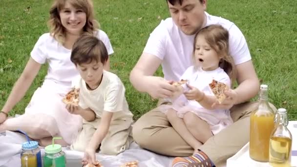 幸せな家族はピザを食べ ピクニックで楽しんでいます — ストック動画