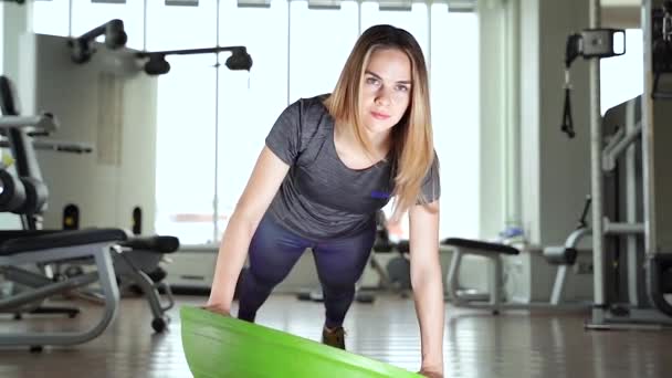 Young woman doing exercise on bosu ball. — Stock Footage Young Woman Doing Exercise Bosu Ball Royalty Free Stock Footage