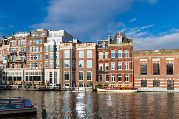 Amsterdam, Netherlands - November 28, 2019: Traditional dutch buildings on canal in Amsterdam