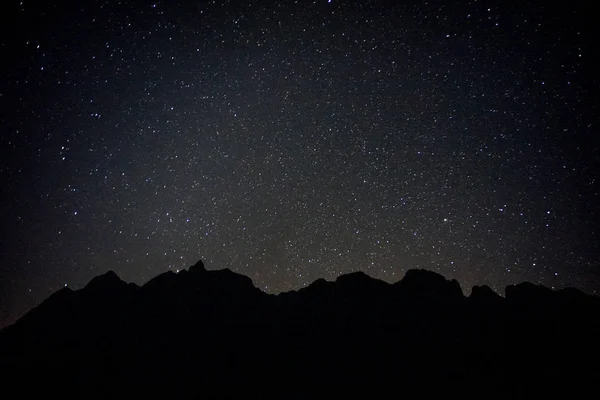 black mountain with full stars in the sky