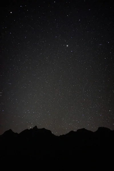 black mountain with full stars in the sky