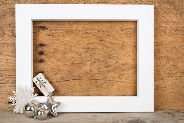 Christmas background - white wooden frame and a gift over a vintage wood- copy space — Stock Photo, Image