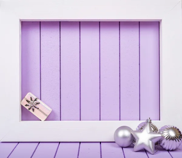 White wooden frame and  christmas decoration over a purple background — Stock Photo, Image