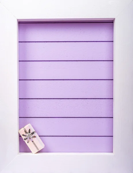 White wooden frame and  christmas decoration over a purple background — Stock Photo, Image
