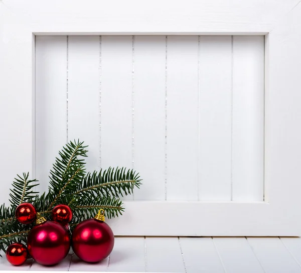 White wooden frame and  christmas decoration over white background — Stock Photo, Image