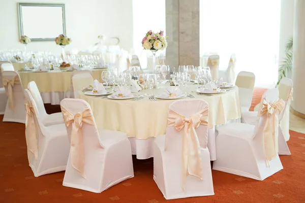 Gyönyörű esküvői virág dekoráció, egy asztal, egy étteremben. Fehér abrosz, világos szoba. — Stock Fotó