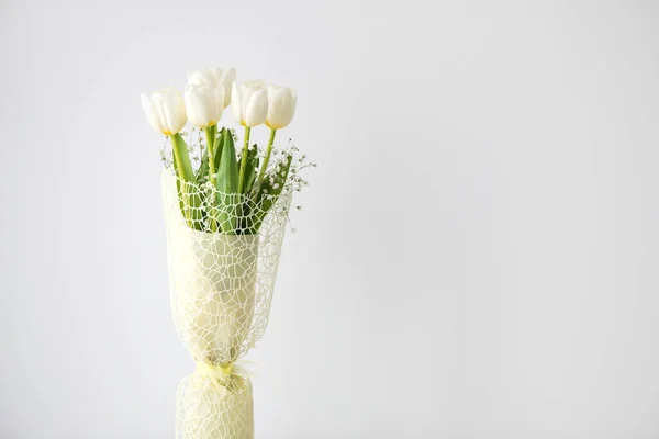 bouquet of white tulips on an antique white furniture - white background, selective focus