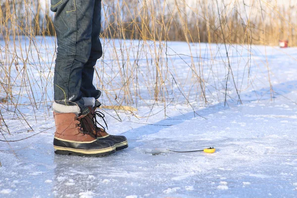 Ice fishing on frozen lake. — Stock Photo, Image