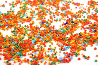 Beyaz arkaplanda renkli boncuklar.