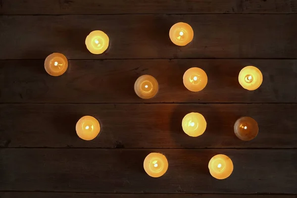 Burning candles  in the darkness. — Stock Photo, Image