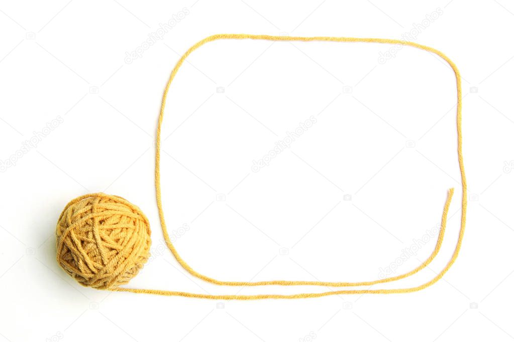 Yellow thread ball with frame made of thread isolated on white background. Cotton thread ball with empty frame.