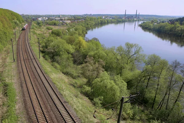 Landscape with railway and river. Railway line near river Nemunas in Lithuania.