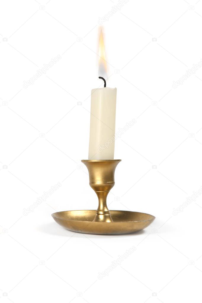Burning  candle in golden vintage candlestick isolated on white background