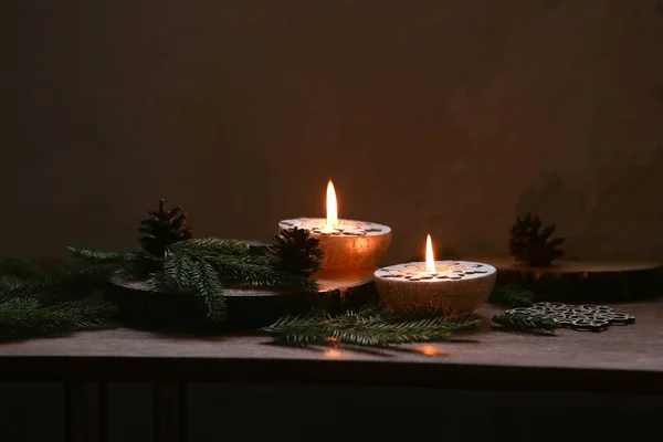 Christmas decoration, Silver candles burning on table decorated with fir branches