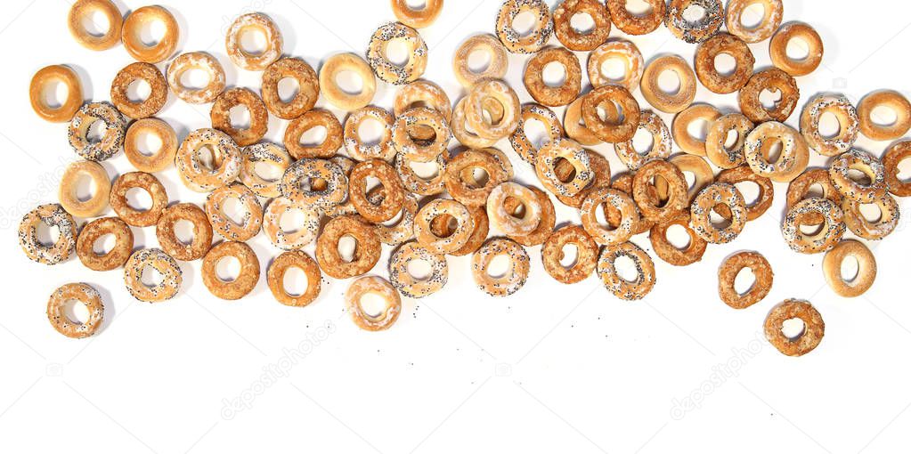 Pile of ring shaped roll cookies with different glaze isolated on white background. Bublik cookies pattern.