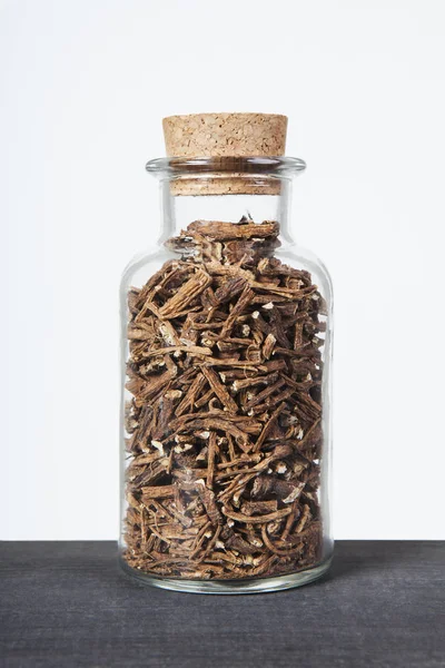 Dried dandelion roots herb inside a glass jar. — Stock Photo, Image