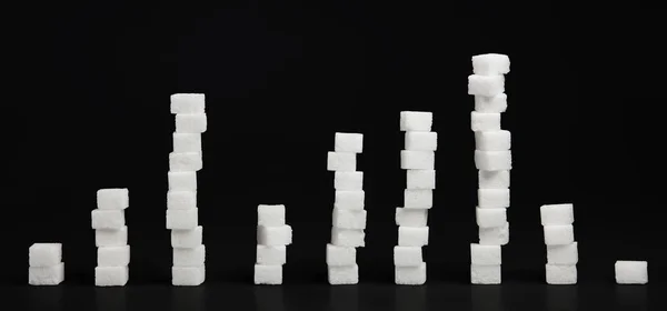 Dokuz sütunlarda düzenlenmiş kesme beyaz şeker. 