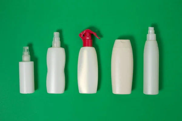 Cosmetics, Moisturizer, Bottle. Different cosmetic bottles. set of cosmetic products. Blank plastic cosmetics bottle isolated on green background with copy space