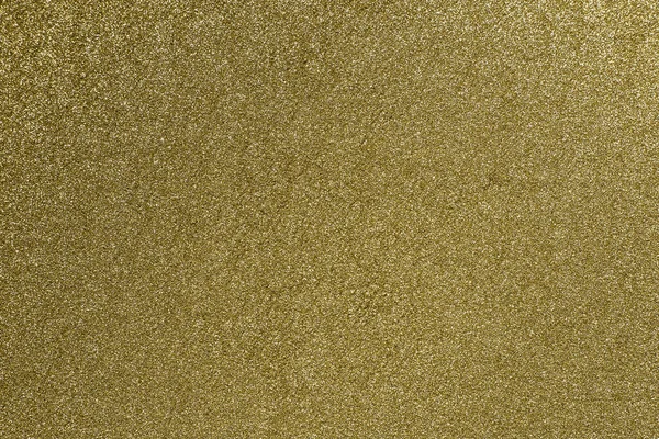 Detailed texture of glittering golden dust surface. Golden Shiny Wallpaper , Perfect for Christmas, New Year or any other Holidays Background. Golden fine powder.