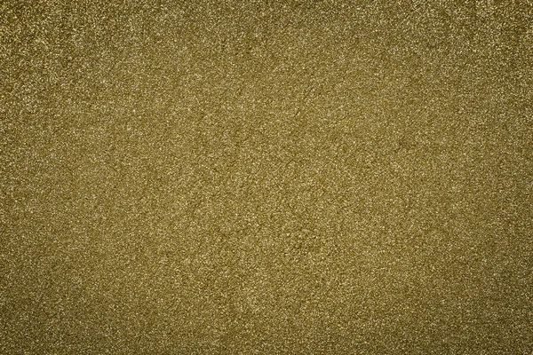 Detailed texture of glittering golden dust surface. Golden Shiny Wallpaper , Perfect for Christmas, New Year or any other Holidays Background. Golden fine powder.