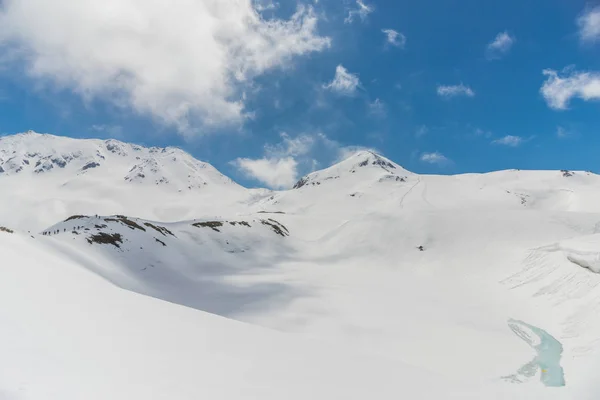 Höga berg under snö med klar blå himmel — Stockfoto