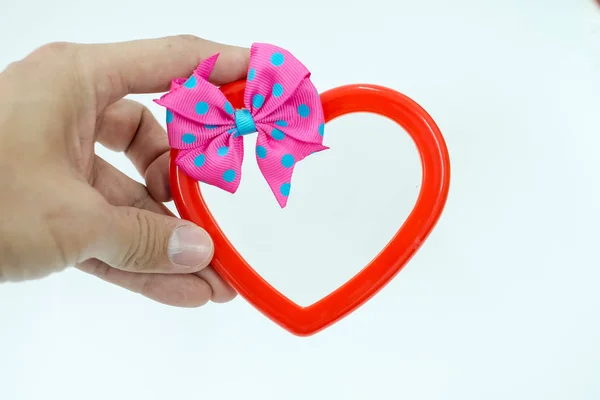 Hand of a young man holding a red heart shaped on white background — Stock Photo, Image