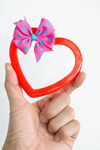 Hand of a young man holding a red heart shaped on white backgrou — Stock Photo, Image