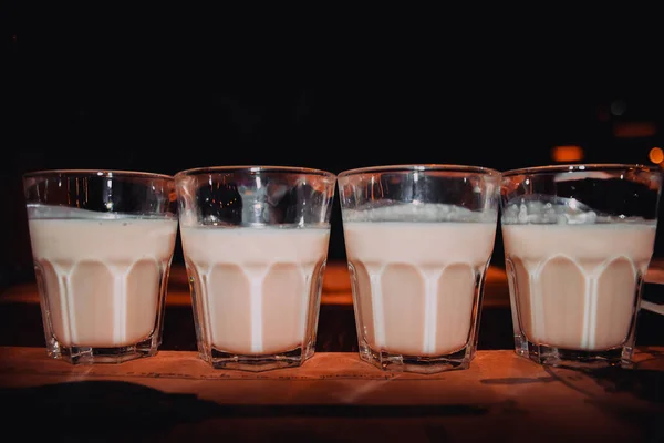 Coffee liqueur, shot glasses with homemade baileys, roasted coffee beans and chocolate, selective focus, toned image — Stock Photo, Image