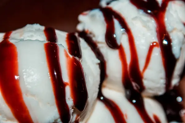 Bola branca de sorvete regada com cobertura de chocolate — Fotografia de Stock