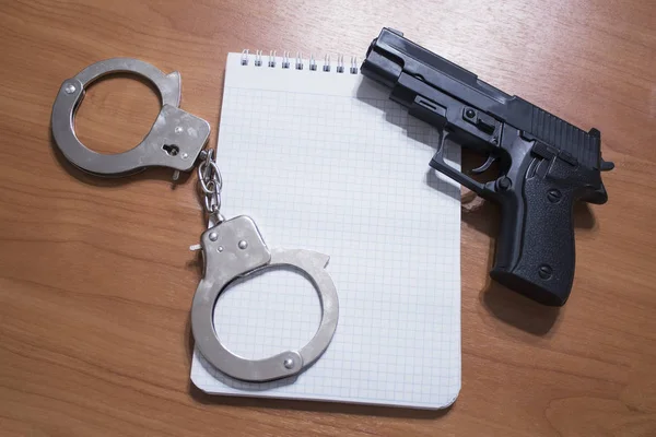 Ручні наручники та блокнот на столі з копіювальним простором — стокове фото