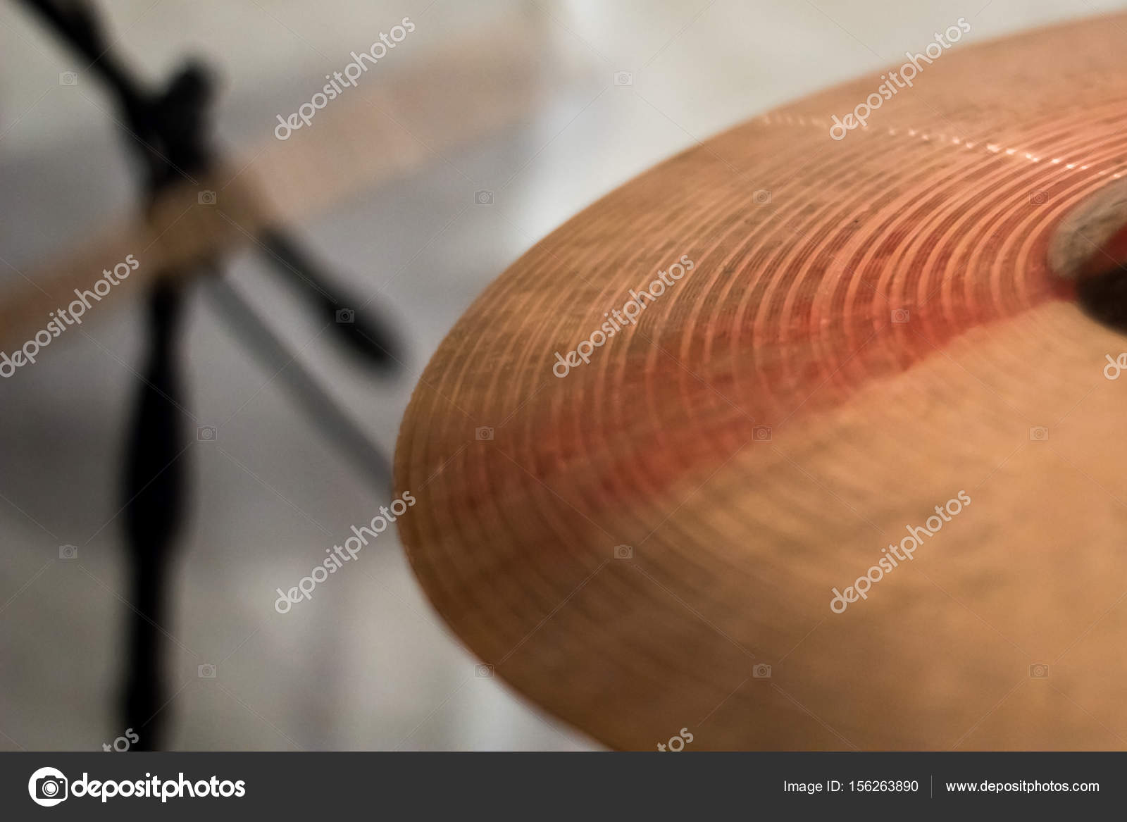 The drum stick hit on the crash cymbal in the low key background