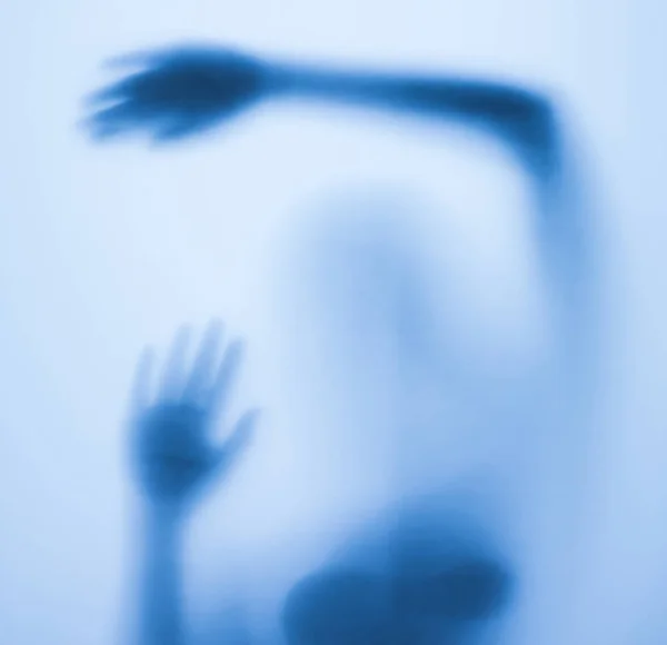 Gruselige Silhouette eines Mädchens hinter einem Glas im Badezimmer — Stockfoto