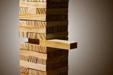 Closeup tahta bloklar, koyu tonu kuleden bir blok almak.